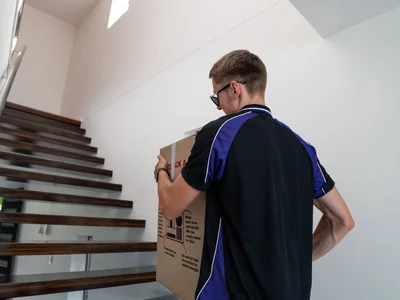 SwiftMove crew moving furniture out of a Brisbane apartment